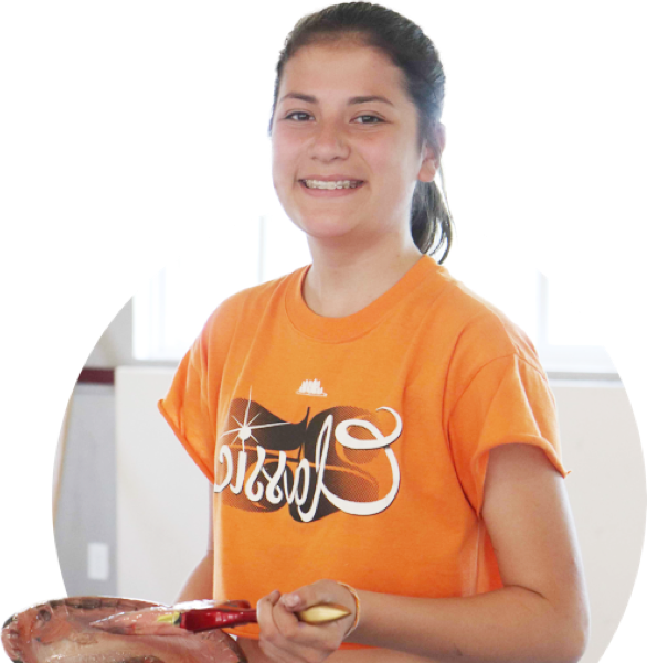 Girl smiling with a paint brush and color palette