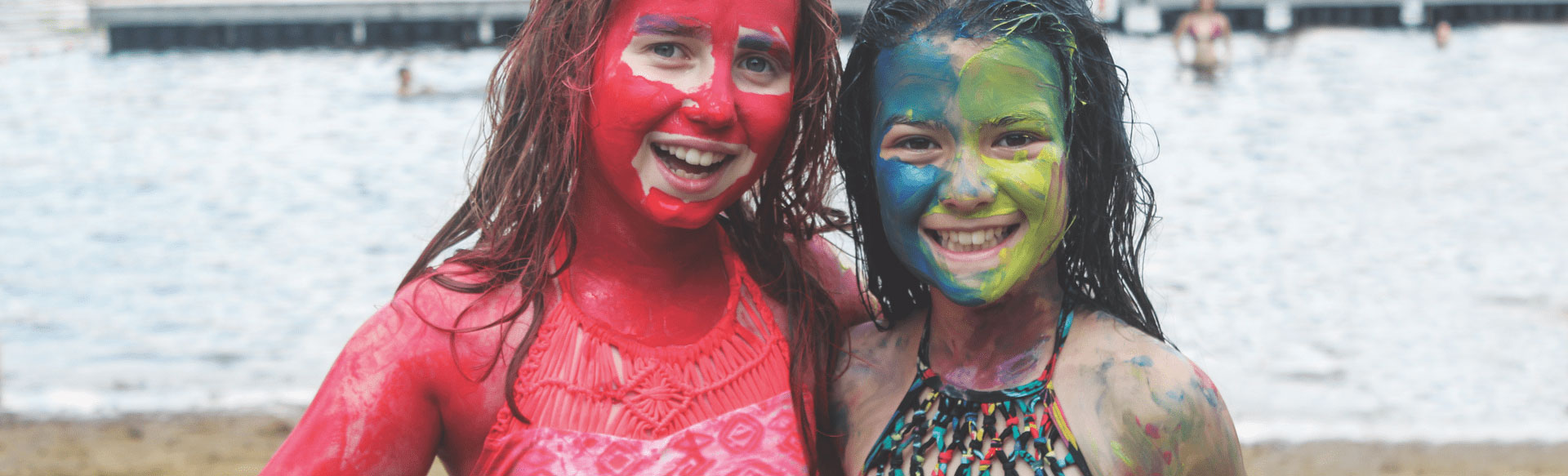 Two girls smiling with paint over their face