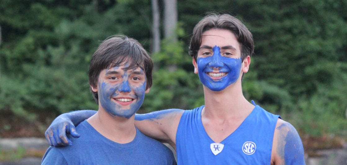 Two boys posing for a photo with paint on their face