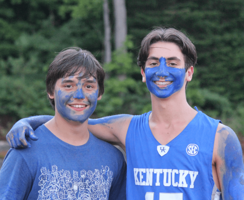 Two boys posing for a photo with paint on their face