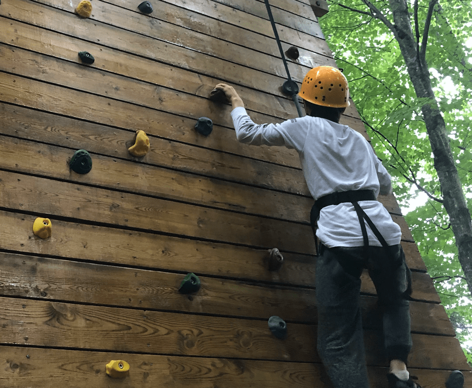 Camper rock climbing at Camp Tamarack