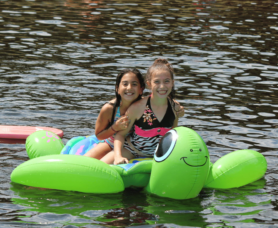 Campers on floaty in the lake