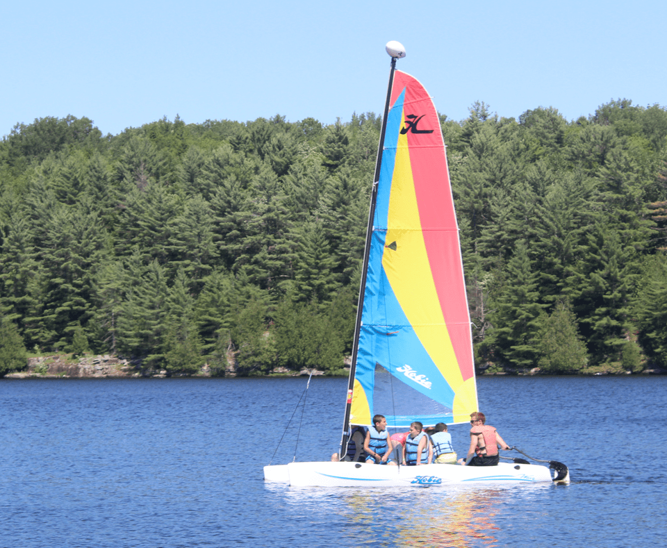 Camper sailing on lake at Camp Tamarack