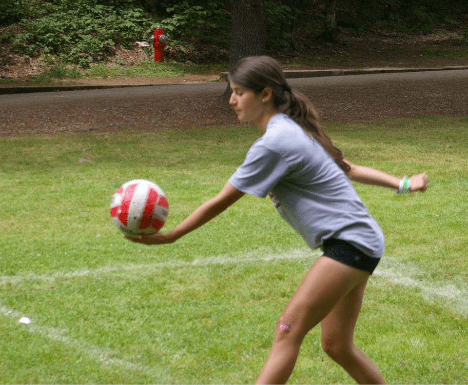 Camper playing volleyball at Camp Tamarack