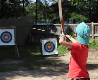 Boy doing archery at Camp Tamarack